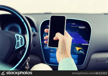 transport, business trip, technology and people concept - close up of male hand with smartphone and navigator on board computer driving car