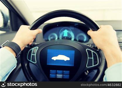 transport, business trip, technology and people concept - close up of male hands holding car wheel and driving with icon on board computer screen