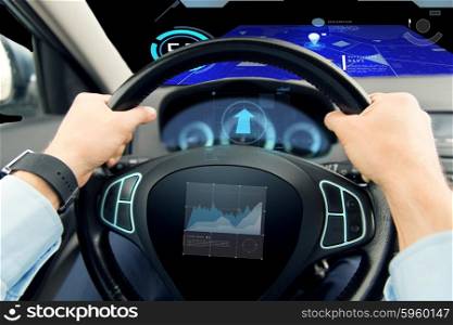 transport, business trip, technology and people concept - close up of male hands holding car wheel and driving with graph on board computer screen