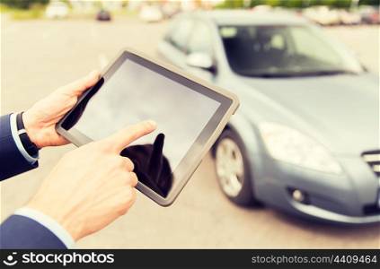 transport, business trip, technology and people concept - close up of young man with tablet pc computer and car outdoors