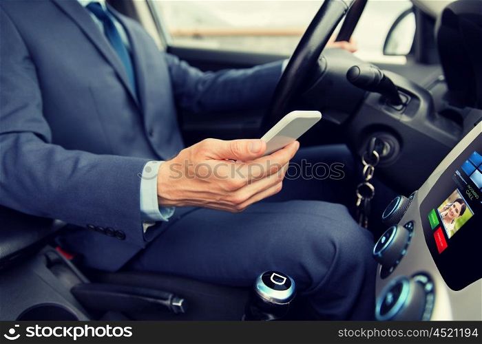 transport, business trip, technology and people concept - close up of young man with smartphone driving car and receiving incoming call from woman on board computer screen