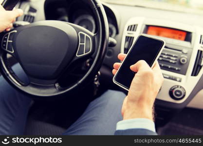 transport, business trip, technology and people concept - close up of young man hand with smartphone driving car