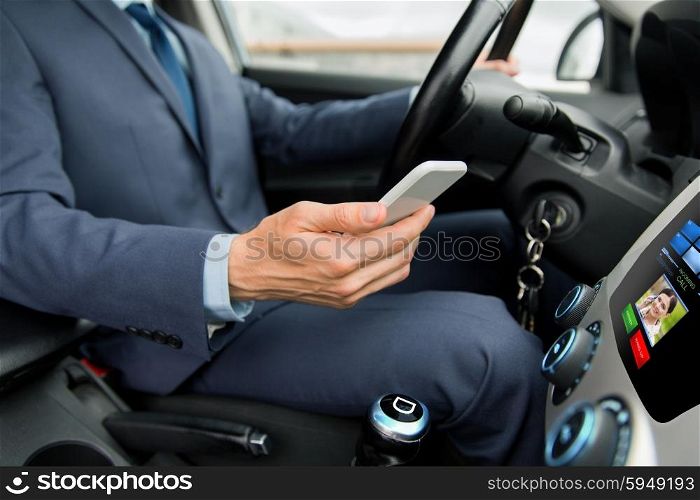 transport, business trip, technology and people concept - close up of young man with smartphone driving car and receiving incoming call from woman on board computer screen