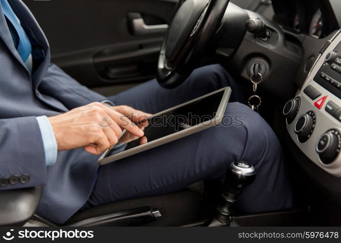 transport, business trip, technology and people concept -close up of young man with tablet pc computer driving car