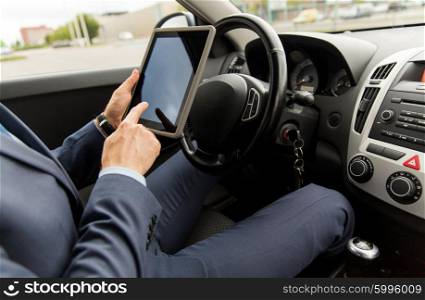 transport, business trip, technology and people concept -close up of young man with tablet pc computer driving car