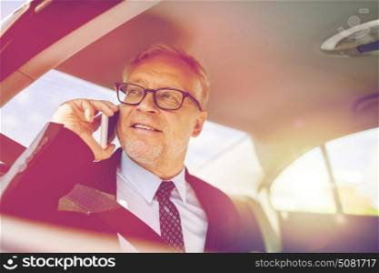 transport, business trip, technology and people concept - senior businessman calling on smartphone and driving on car back seat. senior businessman calling on smartphone in car