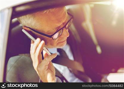 transport, business trip, technology and people concept - senior businessman calling on smartphone and driving on car back seat. senior businessman calling on smartphone in car. senior businessman calling on smartphone in car