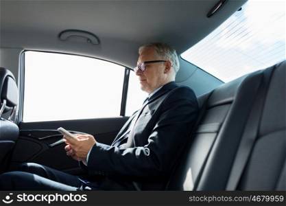 transport, business trip, technology and people concept - senior businessman texting on smartphone and driving on car back seat