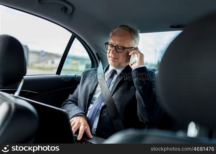 transport, business trip, technology and people concept - senior businessman with laptop computer calling on smartphone and driving on car back seat