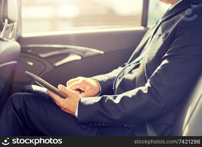 transport, business trip, technology and people concept - senior businessman with tablet pc computer driving on car back seat. senior businessman with tablet pc driving in car