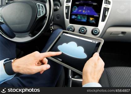 transport, business trip, technology, computing and people concept - close up of male hands holding tablet pc computer with cloud icon on screen in car