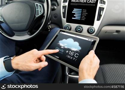 transport, business trip, technology, forecast and people concept - close up of male hands holding tablet pc computer with weather cast on screen in car