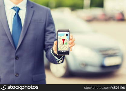 transport, business trip, technology, navigation and people concept - close up of man showing smartphone gps navigator map on screen on car parking