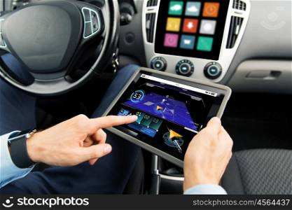 transport, business trip, technology, navigation and people concept - close up of male hands holding tablet pc computer with gps navigator map on screen in car