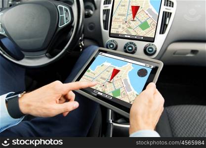 transport, business trip, technology, navigation and people concept - close up of male hands holding tablet pc computer with gps navigator map on screen in car