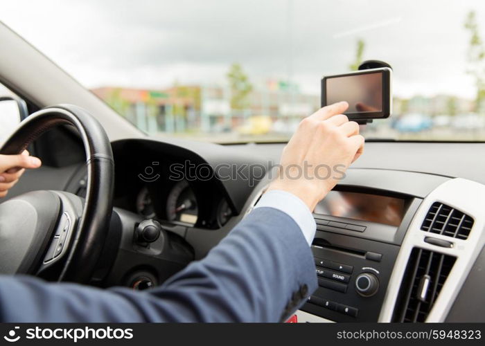 transport, business trip, technology, navigation and people concept - close up of male hand using gps navigator while driving driving car
