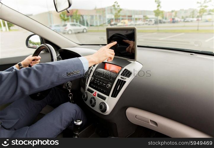 transport, business trip, technology, navigation and people concept -close up of young man with tablet pc computer driving car