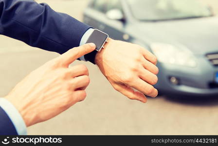 transport, business trip, technology, time and people concept - close up of male hands with wristwatch on car parking