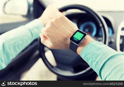 transport, business trip, technology, time and people concept - close up of man with music icon on smart watch driving car