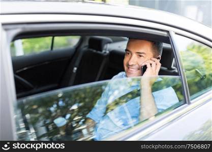 transport, communication and business concept - male passenger or businessman calling on smartphone on back seat of taxi car. male passenger calling on smartphone in taxi car