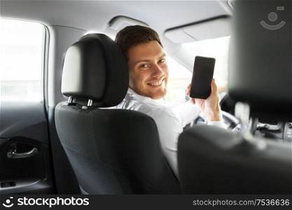 transport, driving and technology concept - man or car driver showing smartphone. man or car driver showing smartphone