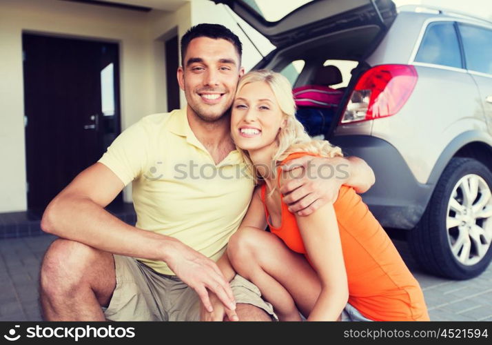 transport, leisure, family and people concept - happy couple hugging at home car parking space