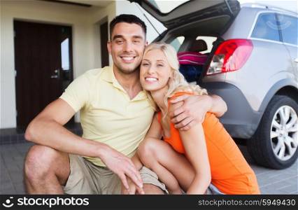 transport, leisure, family and people concept - happy couple hugging at home car parking space