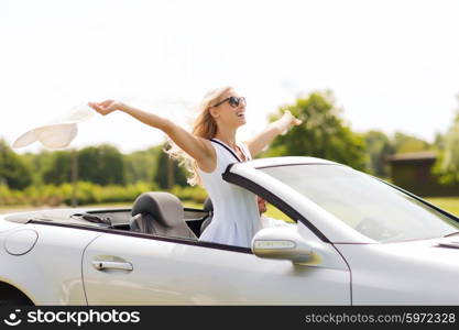 transport, leisure, road trip and people concept - happy man and woman driving in cabriolet car outdoors