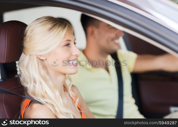 transport, leisure, road trip and people concept - happy man and woman driving car