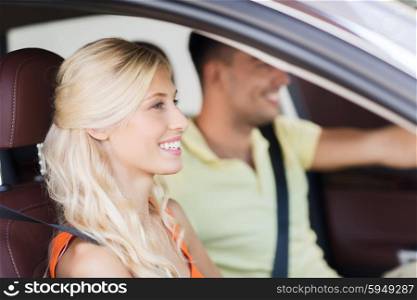 transport, leisure, road trip and people concept - happy man and woman driving car