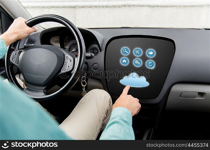 transport, modern technology and people concept - close up of man driving car with menu on board computer screen and cloud icon