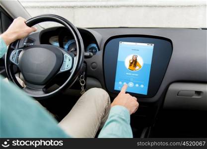 transport, modern technology and people concept - close up of man driving car with music player on board computer screen
