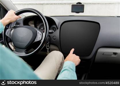 transport, modern technology and people concept - close up of man driving car and pointing finger to blank on-board computer screen