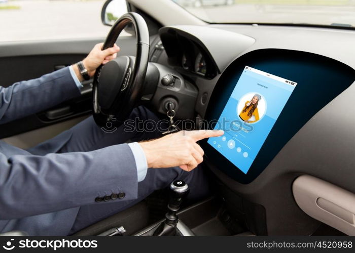 transport, modern technology and people concept - close up of man driving car with music player on board computer screen