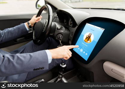 transport, modern technology and people concept - close up of man driving car with music player on board computer screen