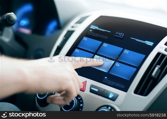 transport, modern technology and people concept - male hand pushing button on car control panel screen