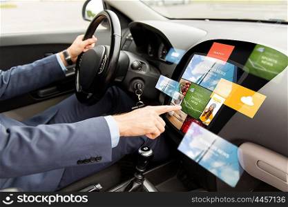 transport, modern technology, business, media and people concept - close up of man driving car with news on board computer screen