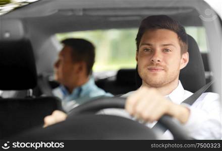 transport, people and taxi concept - male driver driving car with passenger. male taxi driver driving car with passenger