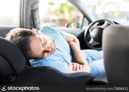 transport, rest and driving concept - tired man or driver sleeping in car. tired man or driver sleeping in car