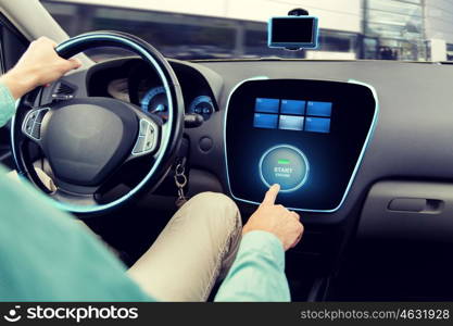 transport, road trip, car driving, technology and people concept - close up of man driving car and pushing start engine button on board computer