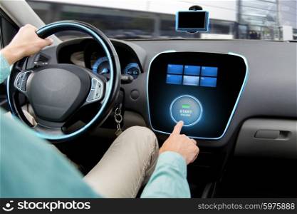 transport, road trip, car driving, technology and people concept - close up of man driving car and pushing start engine button on board computer