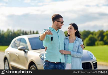transport, road trip, travel, family and people concept - happy man and woman with car key hugging