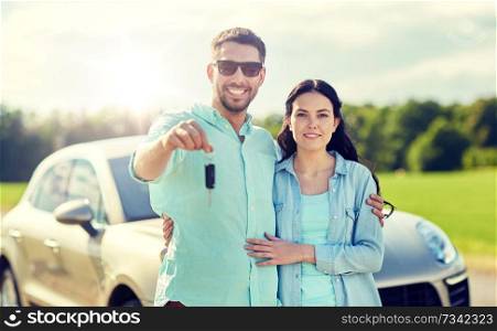 transport, road trip, travel, family and people concept - happy man and woman with car key hugging . happy man and woman with car key hugging