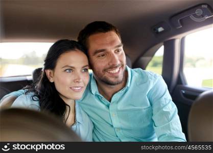 transport, road trip, travel, family and people concept - happy man and woman hugging in car