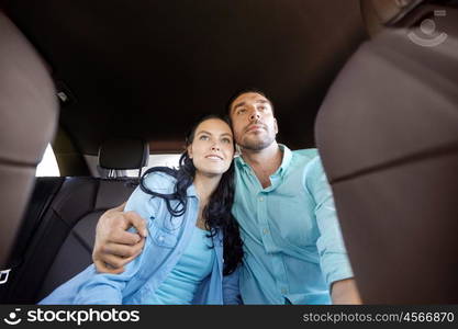 transport, road trip, travel, family and people concept - happy man and woman hugging in car