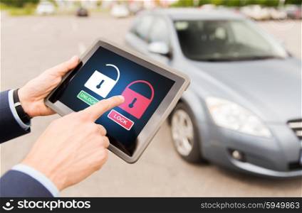 transport, safety, security, technology and people concept - close up of male hands with lock icons on tablet pc computer screen and car outdoors