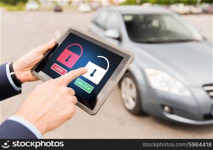 transport, safety, security, technology and people concept - close up of male hands with lock and unlock icon on tablet pc computer screen and car outdoors