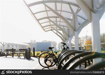 transport, storage and safety concept - close up of bicycle street parking outdoors