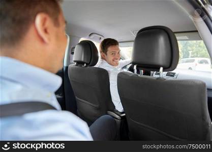 transport, taxi and people concept - male driver driving car with passenger. male driver driving car with passenger