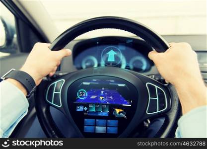 transport, technology, navigation, destination and people concept - close up of male hands holding car wheel and driving with gps navigator on wheel computer screen